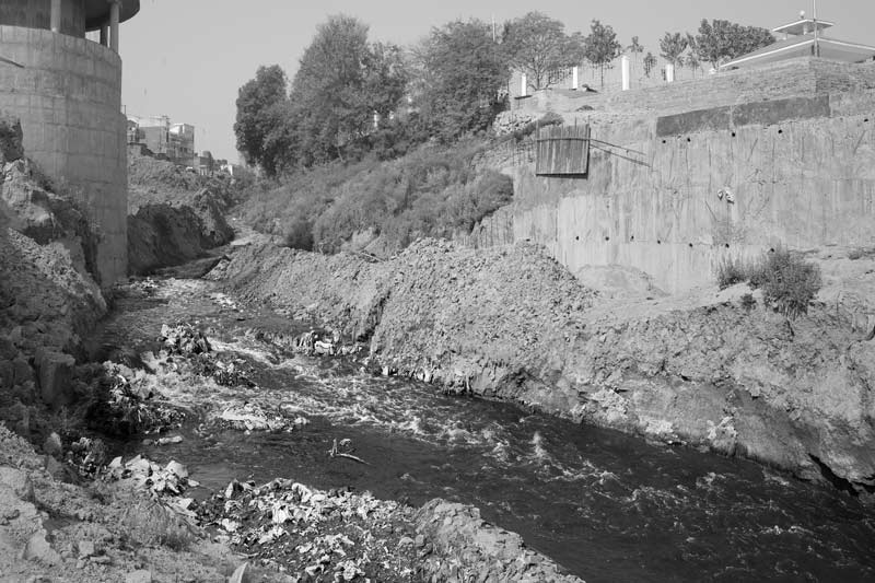 Challenges Impacting the Connection between Water and Religion - River Asi, a tributary of holy river Ganga - carrying the city's untreated wastewater in Varanasi, Uttar Pradesh